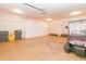 Spacious garage featuring storage cabinets, side door, and a golf cart at 1655 Rosebud Ln, Greenwood, IN 46143