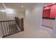 Hallway with staircase, open doorway to bathroom and elegant chandelier lighting the space at 1655 Rosebud Ln, Greenwood, IN 46143