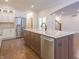 Kitchen island features granite counters, stainless appliances, hardwood floors and a sink at 1655 Rosebud Ln, Greenwood, IN 46143