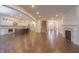 Spacious living room showcasing open floor plan with hardwood floors, fireplace, and a kitchen view at 1655 Rosebud Ln, Greenwood, IN 46143