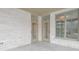 Covered patio with brick wall, glass windows, and doors offers a view of the outdoors at 1655 Rosebud Ln, Greenwood, IN 46143