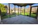 Inviting screened porch with a concrete floor offering views of the serene backyard at 1655 Rosebud Ln, Greenwood, IN 46143