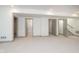 Finished basement featuring neutral carpet, trim, multiple entry doors and a bathroom at 1818 Central Ave, Indianapolis, IN 46202