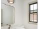 Contemporary bathroom with sleek vanity, modern mirror, and a black framed window at 1818 Central Ave, Indianapolis, IN 46202