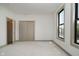 This is a bedroom with carpet, two windows, closet, and white walls at 1818 Central Ave, Indianapolis, IN 46202