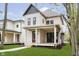 Charming two-story home with covered front porch, green lawn and meticulous landscaping in a verdant neighborhood at 1818 Central Ave, Indianapolis, IN 46202