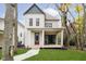 Beautiful two-story home with a covered porch, green lawn and mature trees at 1818 Central Ave, Indianapolis, IN 46202