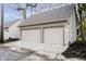 Two-car garage with carriage doors surrounded by lush foliage in a quiet, upscale neighborhood at 1818 Central Ave, Indianapolis, IN 46202