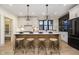 Bright kitchen features modern appliances, stylish island with seating and elegant pendant lighting at 1818 Central Ave, Indianapolis, IN 46202