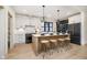 Modern kitchen with large island, seating, stainless steel appliances and hardwood floors at 1818 Central Ave, Indianapolis, IN 46202