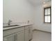 This laundry room features a stainless steel sink, modern fixtures, and a tiled floor at 1818 Central Ave, Indianapolis, IN 46202