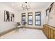 Well-lit office space with a glass-top desk, modern chandelier, and neutral tones at 1818 Central Ave, Indianapolis, IN 46202
