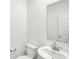 Bright bathroom features a white vanity, modern faucet, toilet, and a large mirror at 2004 Foothill Dr, Greenfield, IN 46140