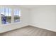 Bright bedroom features neutral carpet and a large double window offering views of the neighborhood at 2004 Foothill Dr, Greenfield, IN 46140