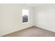 Bright bedroom features neutral carpet and a window with neighborhood views at 2004 Foothill Dr, Greenfield, IN 46140