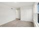 Bright bedroom features neutral carpet, closet, and a large window offering neighborhood views at 2004 Foothill Dr, Greenfield, IN 46140