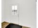 Bright entryway with a white door featuring glass panes and a view of the outdoors, complemented by sleek laminate flooring at 2004 Foothill Dr, Greenfield, IN 46140
