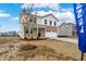 Attractive two-story home showcasing a brick and vinyl exterior, a small tree, and a freshly poured concrete driveway at 2004 Foothill Dr, Greenfield, IN 46140