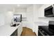 Bright kitchen boasts stainless steel appliances, white cabinetry, and a large island with a sink at 2004 Foothill Dr, Greenfield, IN 46140