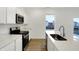 Modern kitchen featuring stainless steel appliances, white cabinets, and a center island with sink at 2004 Foothill Dr, Greenfield, IN 46140