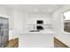 The kitchen features a big island, stainless steel appliances, and white cabinetry at 2004 Foothill Dr, Greenfield, IN 46140