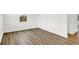 Spacious room featuring laminate flooring, white walls, and a window offering a view of the neighborhood at 2004 Foothill Dr, Greenfield, IN 46140