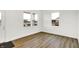 Bright living room with laminate flooring, white walls, and large windows offering a clear view of the neighborhood at 2004 Foothill Dr, Greenfield, IN 46140