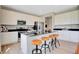 Kitchen boasts white cabinetry, stainless steel appliances, a large island with stool seating, and modern countertops at 2134 Boxwood Dr, Greenfield, IN 46140