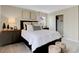Comfortable bedroom features a patterned accent wall with a large bed and modern furnishings at 2134 Boxwood Dr, Greenfield, IN 46140