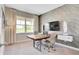 Stylish home office featuring a wood accent wall, large window, modern desk, and comfortable seating for productivity at 2134 Boxwood Dr, Greenfield, IN 46140