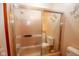 Shower featuring tiled walls with a decorative splash wall art and frosted glass door at 2566 S Ritter Ave, Indianapolis, IN 46203