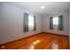 Sunlit bedroom with gleaming hardwood floors and calming blue walls at 2566 S Ritter Ave, Indianapolis, IN 46203