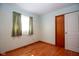 Simple bedroom featuring hardwood floors, natural light, and a convenient closet at 2566 S Ritter Ave, Indianapolis, IN 46203