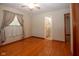 Bedroom featuring hardwood floors, large window, and attached bathroom at 2566 S Ritter Ave, Indianapolis, IN 46203