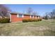 Side view of home, showing brick exterior and manicured landscaping for curb appeal at 2566 S Ritter Ave, Indianapolis, IN 46203