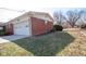 Side view of the home with a one-car garage and partial yard view at 2566 S Ritter Ave, Indianapolis, IN 46203