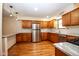 Bright kitchen equipped with stainless steel appliances, wood cabinets and modern marble countertops at 2566 S Ritter Ave, Indianapolis, IN 46203