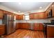 Well-lit kitchen featuring stainless steel appliances, wood cabinets, and stylish countertops at 2566 S Ritter Ave, Indianapolis, IN 46203