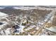 Birds eye view of home, outbuildings, and surrounding wooded acreage with snow-covered ground at 2843 E 236Th St, Cicero, IN 46034