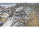 Aerial view of a home with outbuildings surrounded by snowy fields and trees at 2843 E 236Th St, Cicero, IN 46034