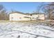 Backyard view of home with snowy ground and bare trees in winter at 2843 E 236Th St, Cicero, IN 46034