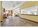 Bright open basement area with tile flooring, custom bench and open kitchen at 2843 E 236Th St, Cicero, IN 46034