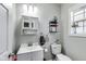 Cozy half bathroom featuring a sink, toilet, storage shelves, and a small window at 2962 Station St, Indianapolis, IN 46218
