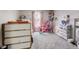Bright bedroom with a platform bed, pink curtains, dollhouse and lots of toys at 2962 Station St, Indianapolis, IN 46218