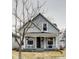 Charming home featuring a covered front porch, neutral siding, and inviting curb appeal at 2962 Station St, Indianapolis, IN 46218