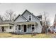 Inviting two-story home showcases neutral siding, a covered porch, and a well-maintained yard at 2962 Station St, Indianapolis, IN 46218