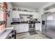 Well-lit kitchen featuring white cabinets, stainless steel appliances, and functional workspace at 2962 Station St, Indianapolis, IN 46218