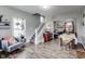 Bright living area featuring hardwood floors, open staircase, and seamless flow to the dining area at 2962 Station St, Indianapolis, IN 46218