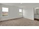 Bright bedroom features neutral carpet, white walls and trim, with large windows providing natural light at 2996 Grand Ridge Dr, Greenwood, IN 46143