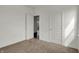 Neutral carpeted bedroom with white walls and trim with views of a door to the hallway at 2996 Grand Ridge Dr, Greenwood, IN 46143